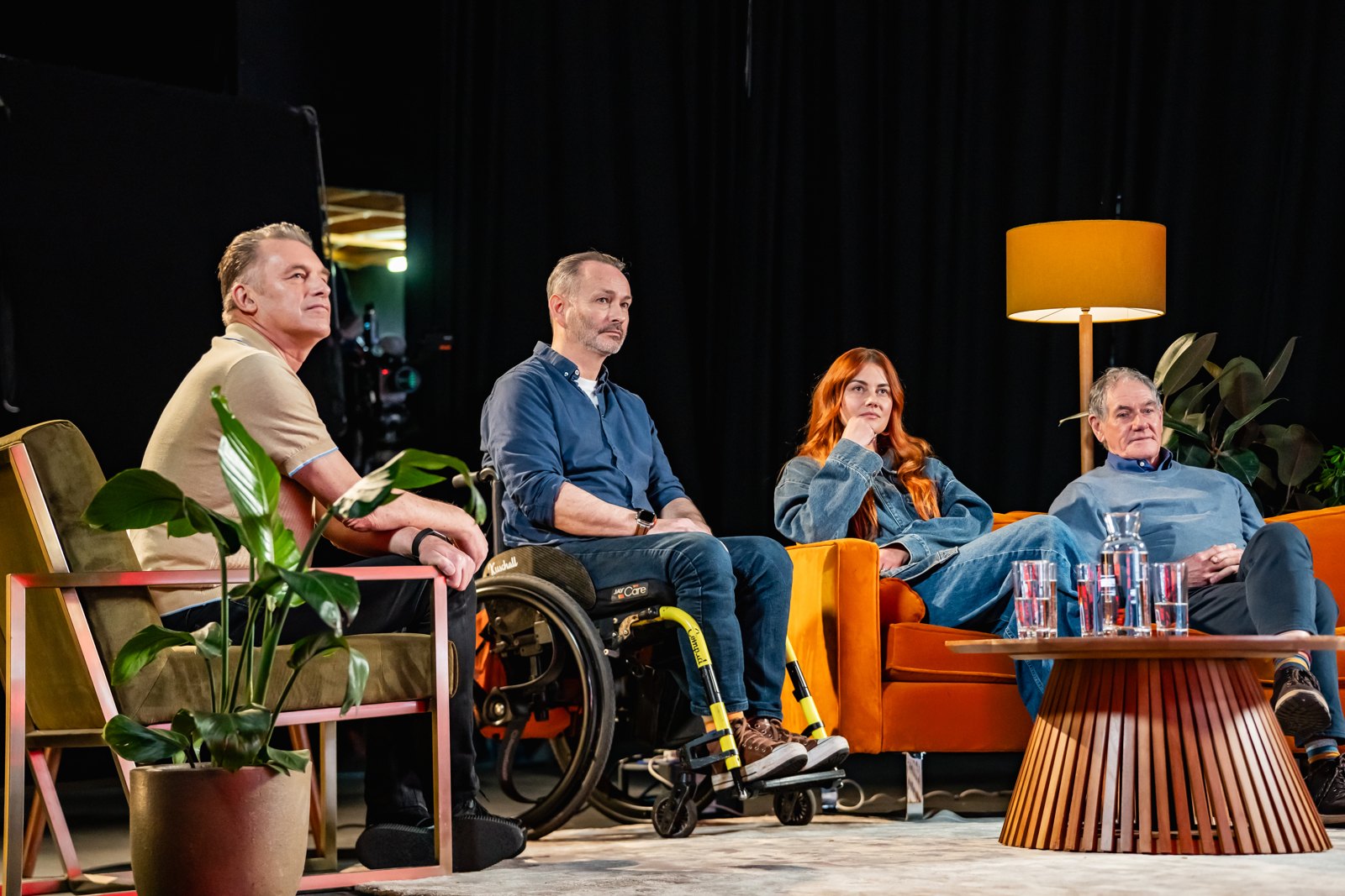 Four adults seated together during filming of The People's Emergency Briefing